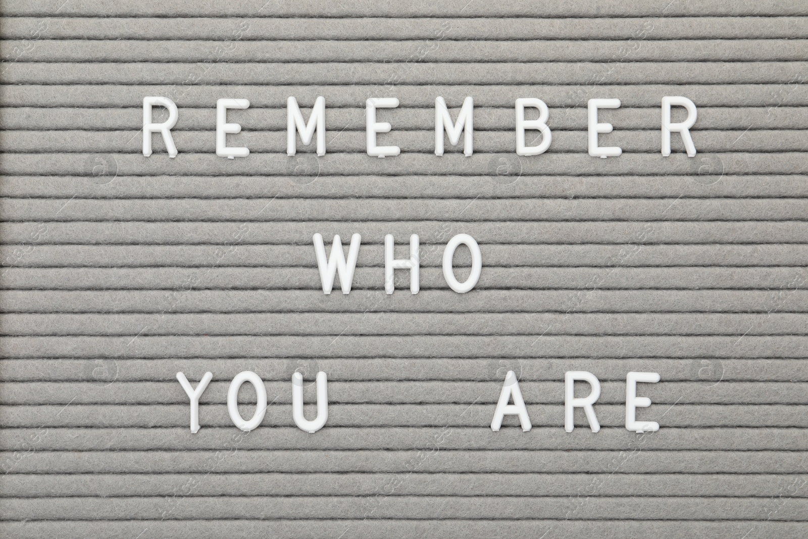 Photo of Letter board with phrase Remember who you are as background, top view