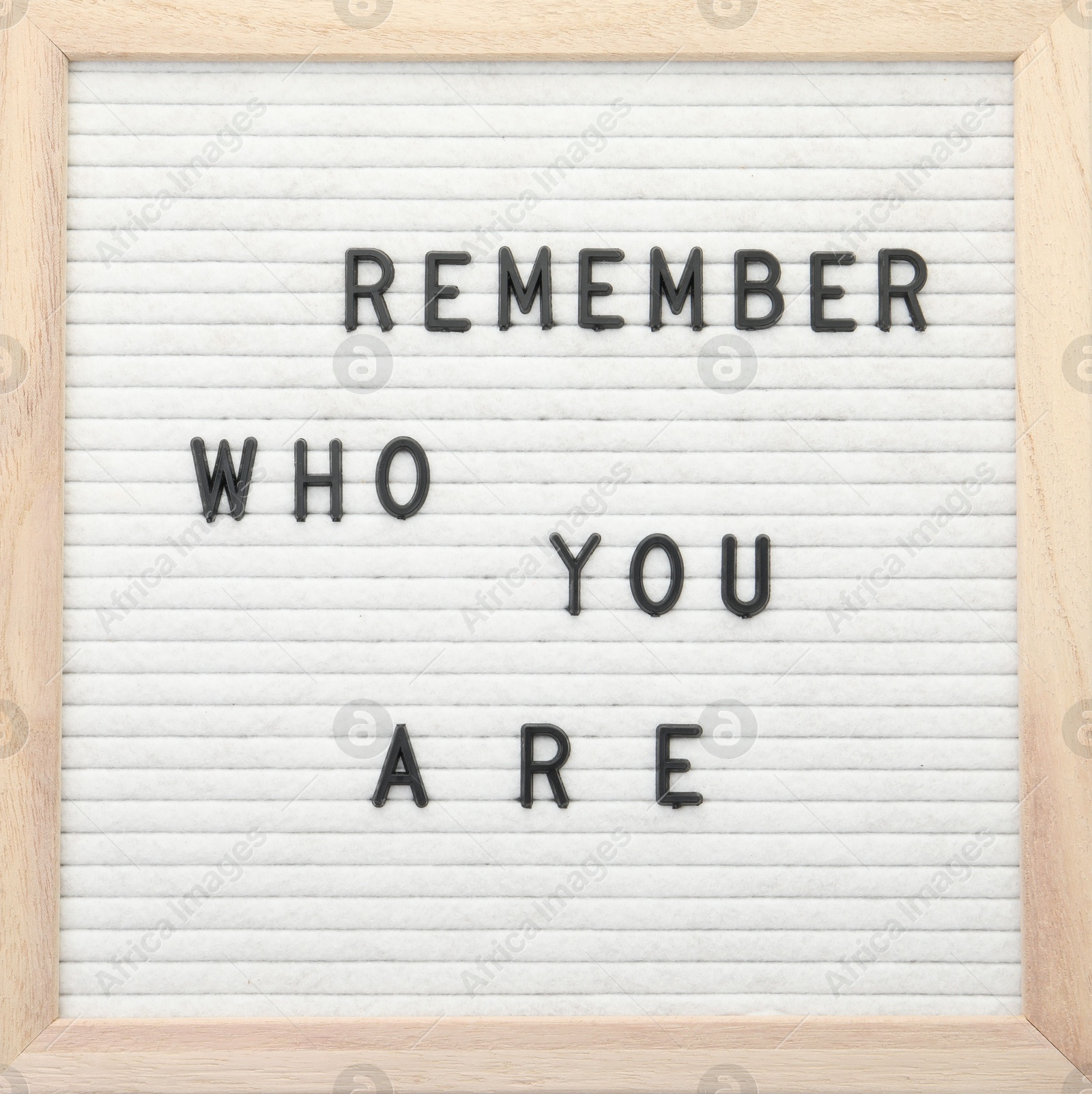 Photo of Letter board with phrase Remember who you are on white background, top view