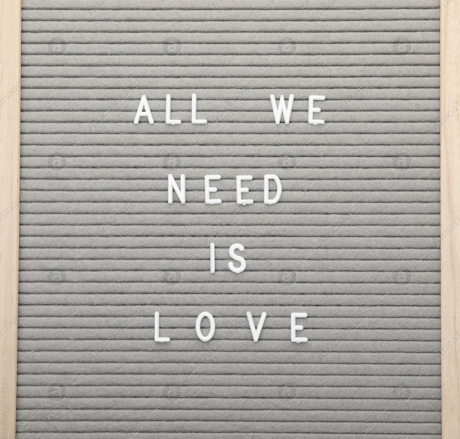 Photo of Letter board with phrase All we need is love on white background, top view