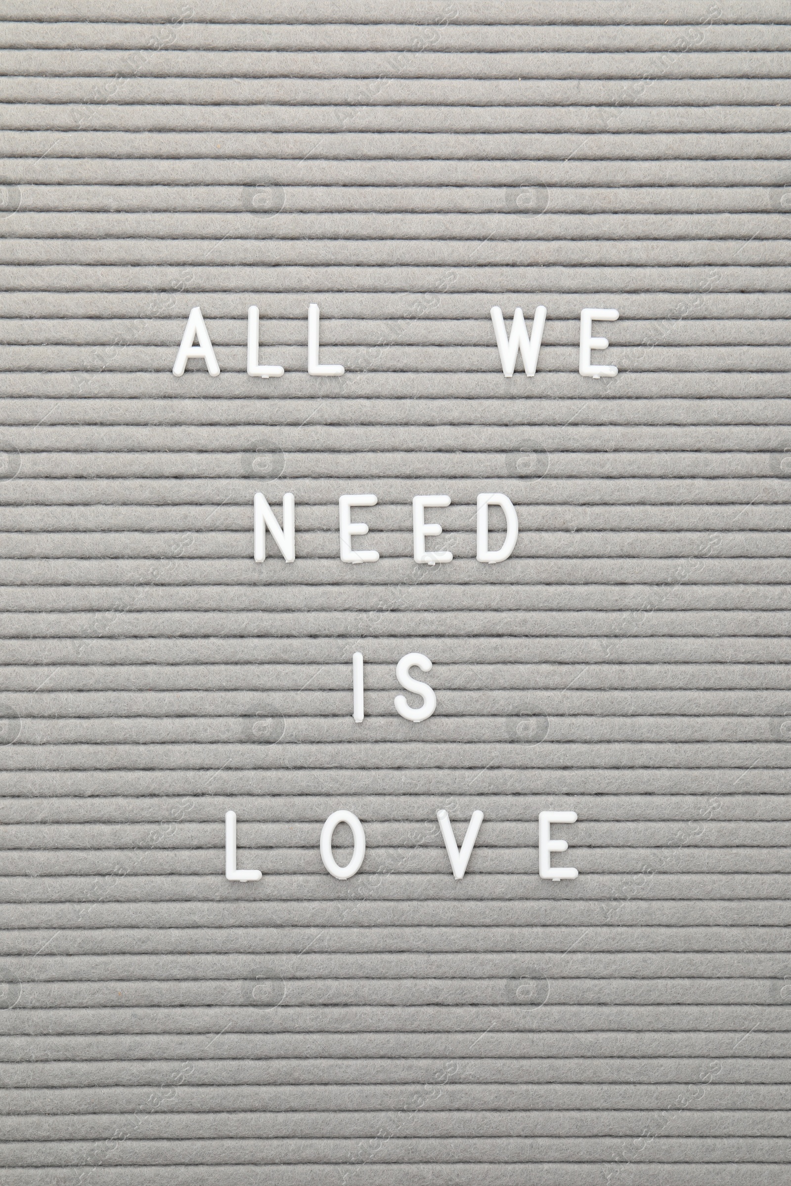 Photo of Letter board with phrase All we need is love as background, top view