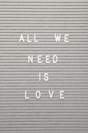 Photo of Letter board with phrase All we need is love as background, top view