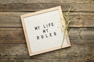 Photo of Letter board with phrase My Life My Rules and beautiful flower on wooden table, top view