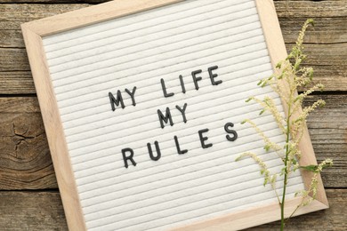 Letter board with phrase My Life My Rules and beautiful flower on wooden table, top view