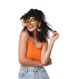 Smiling young woman wearing carnival mask on white background