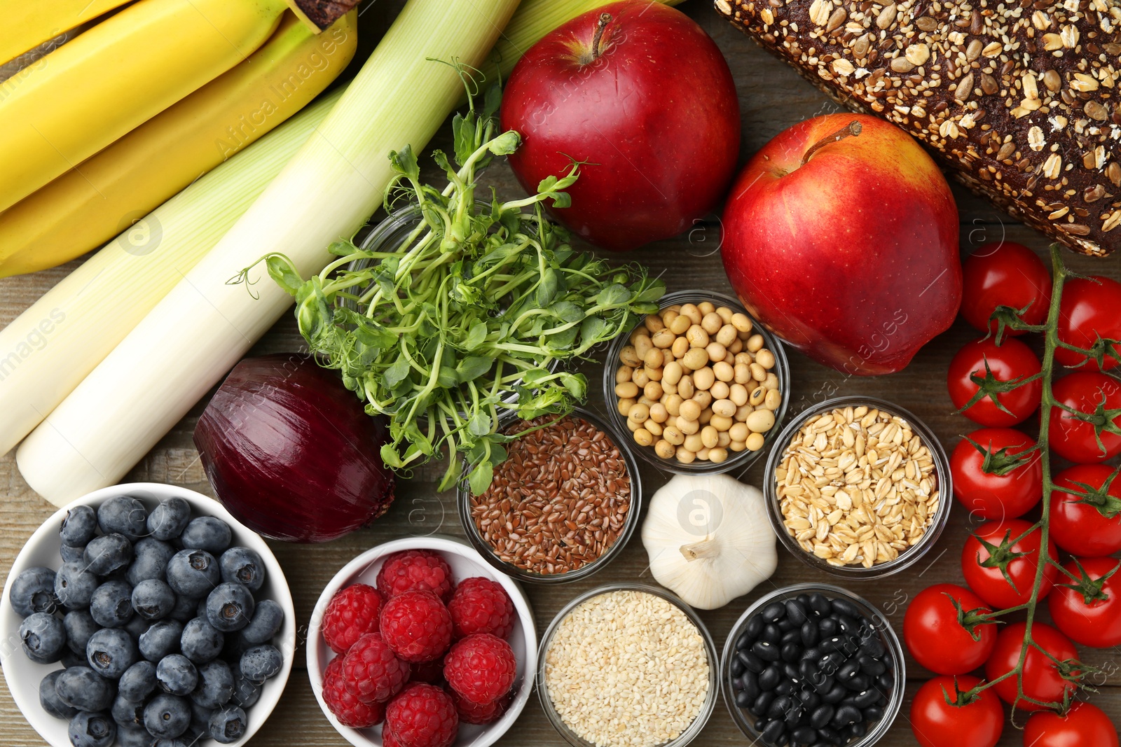 Photo of Different fresh products on wooden table, flat lay. Source of prebiotics