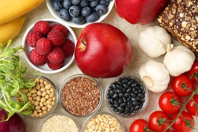 Photo of Different fresh products on grey table, flat lay. Source of prebiotics