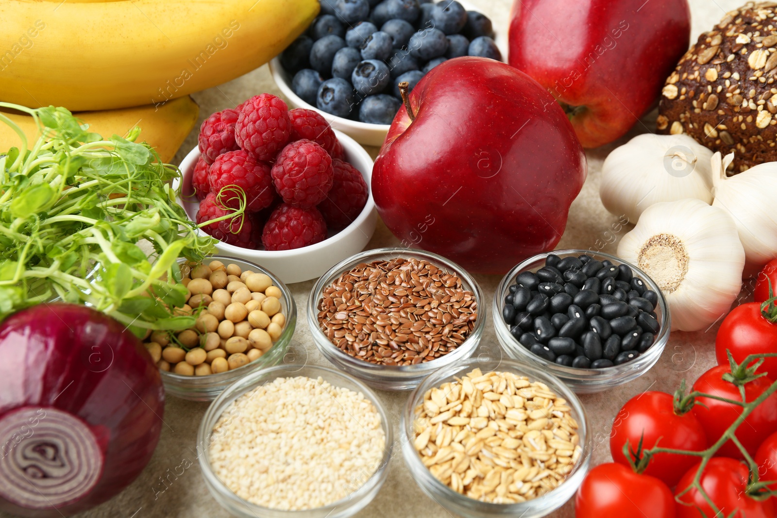 Photo of Different fresh products on grey table. Source of prebiotics