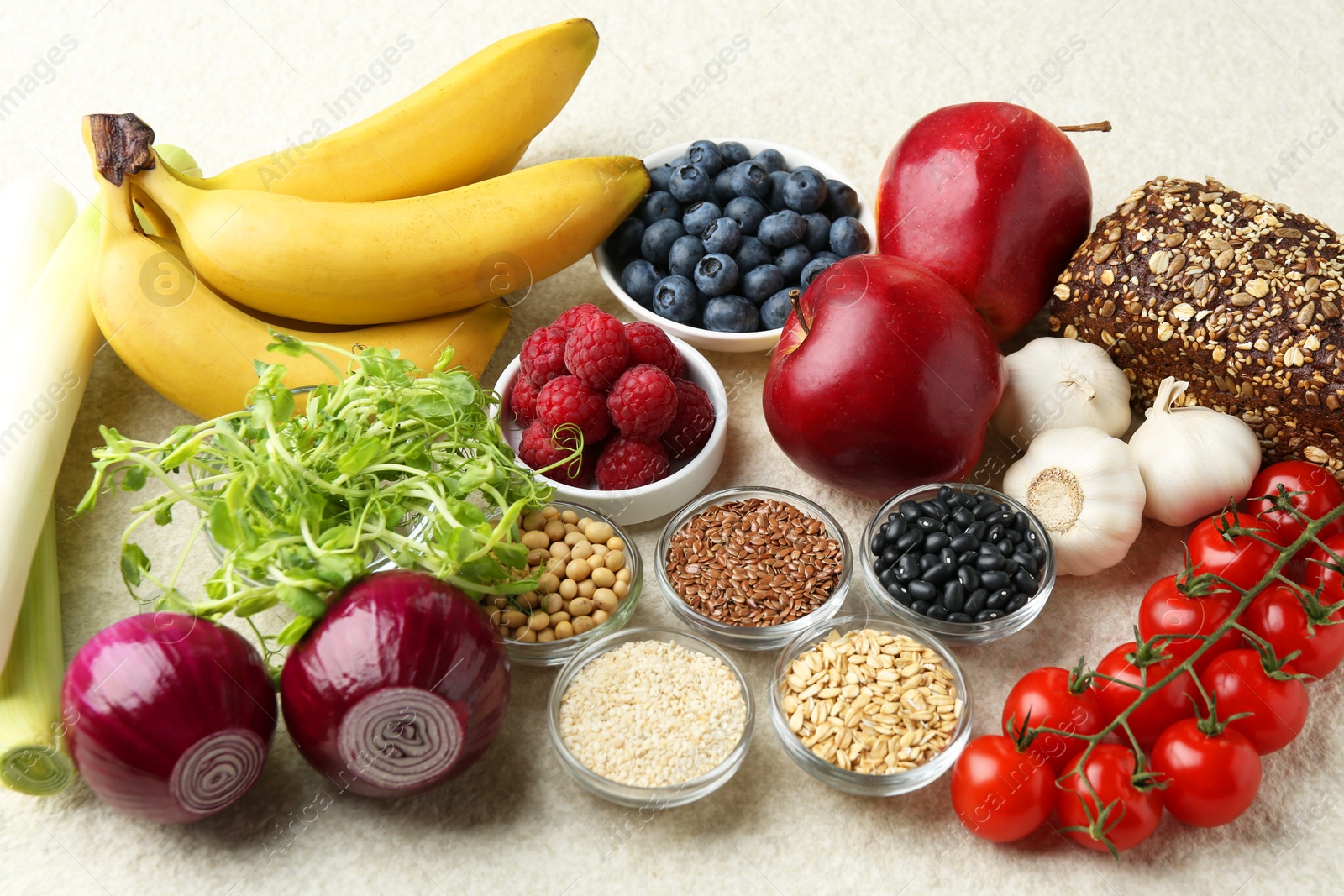 Photo of Different fresh products on grey table. Source of prebiotics