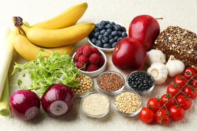 Photo of Different fresh products on grey table. Source of prebiotics