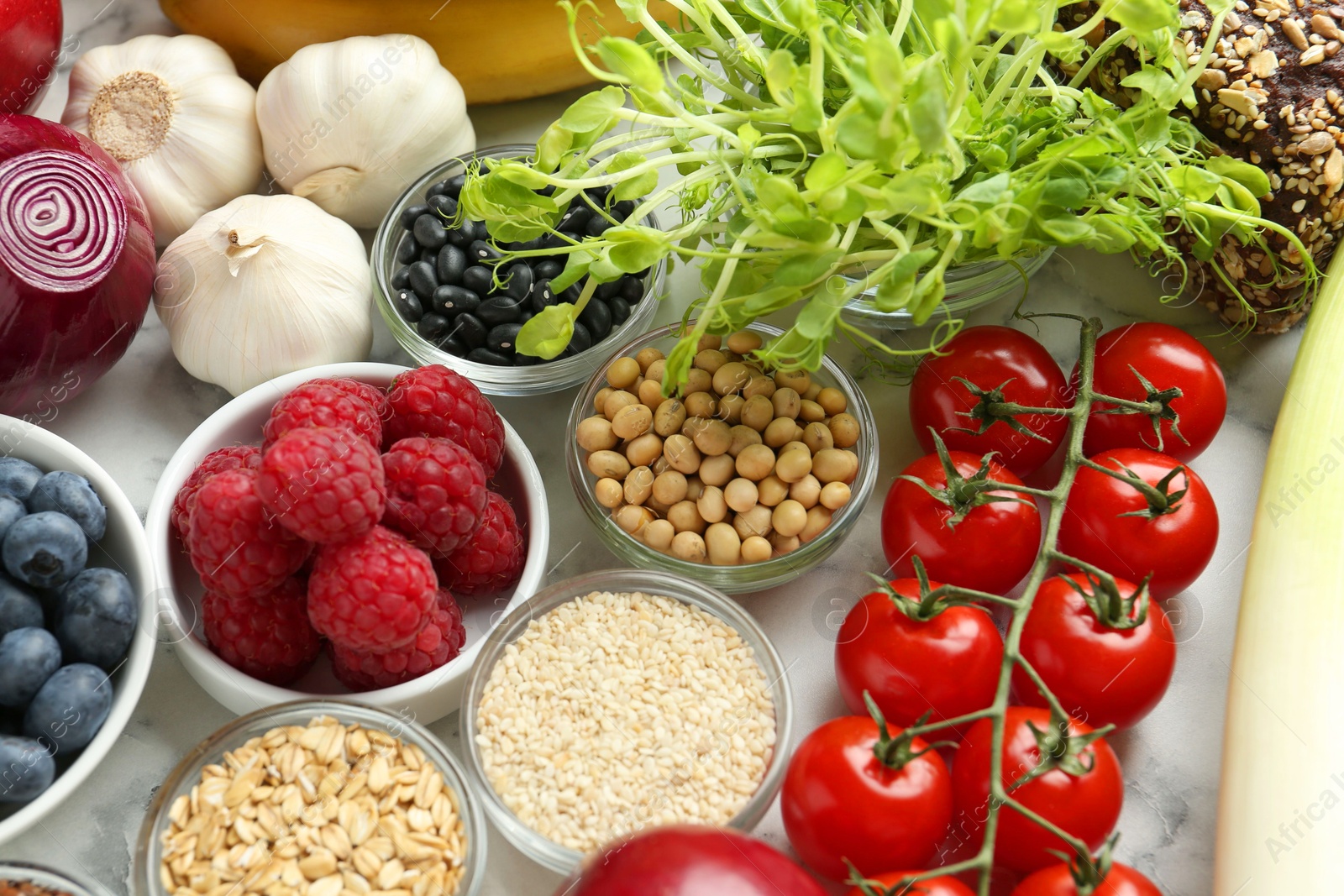 Photo of Different fresh products on white table. Source of prebiotics