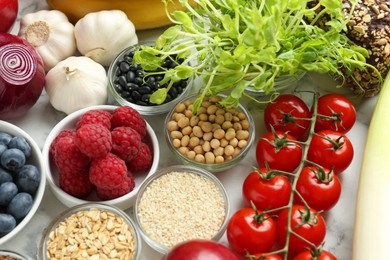 Photo of Different fresh products on white table. Source of prebiotics