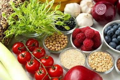 Photo of Different fresh products on white table. Source of prebiotics