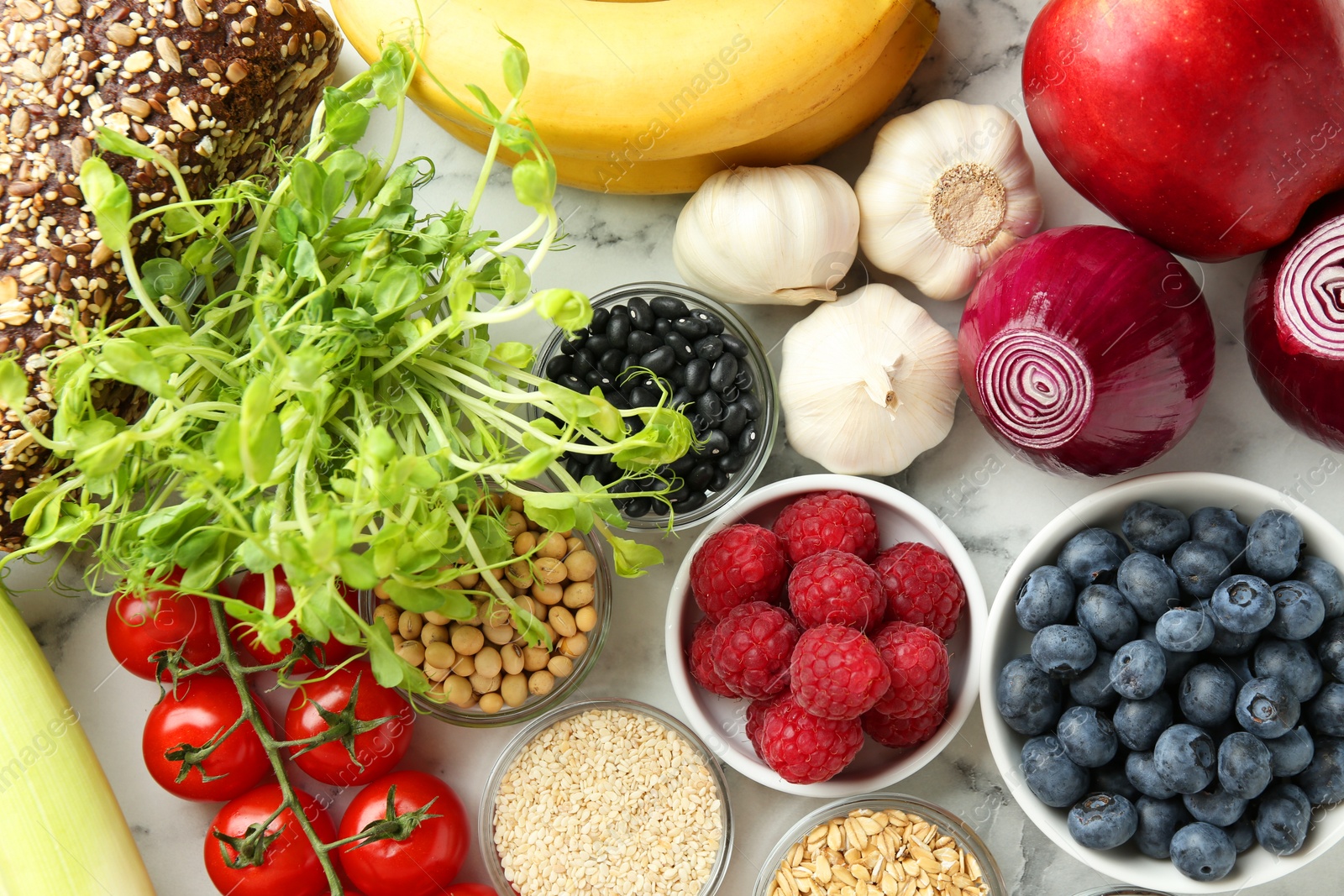 Photo of Different fresh products on white table, flat lay. Source of prebiotics