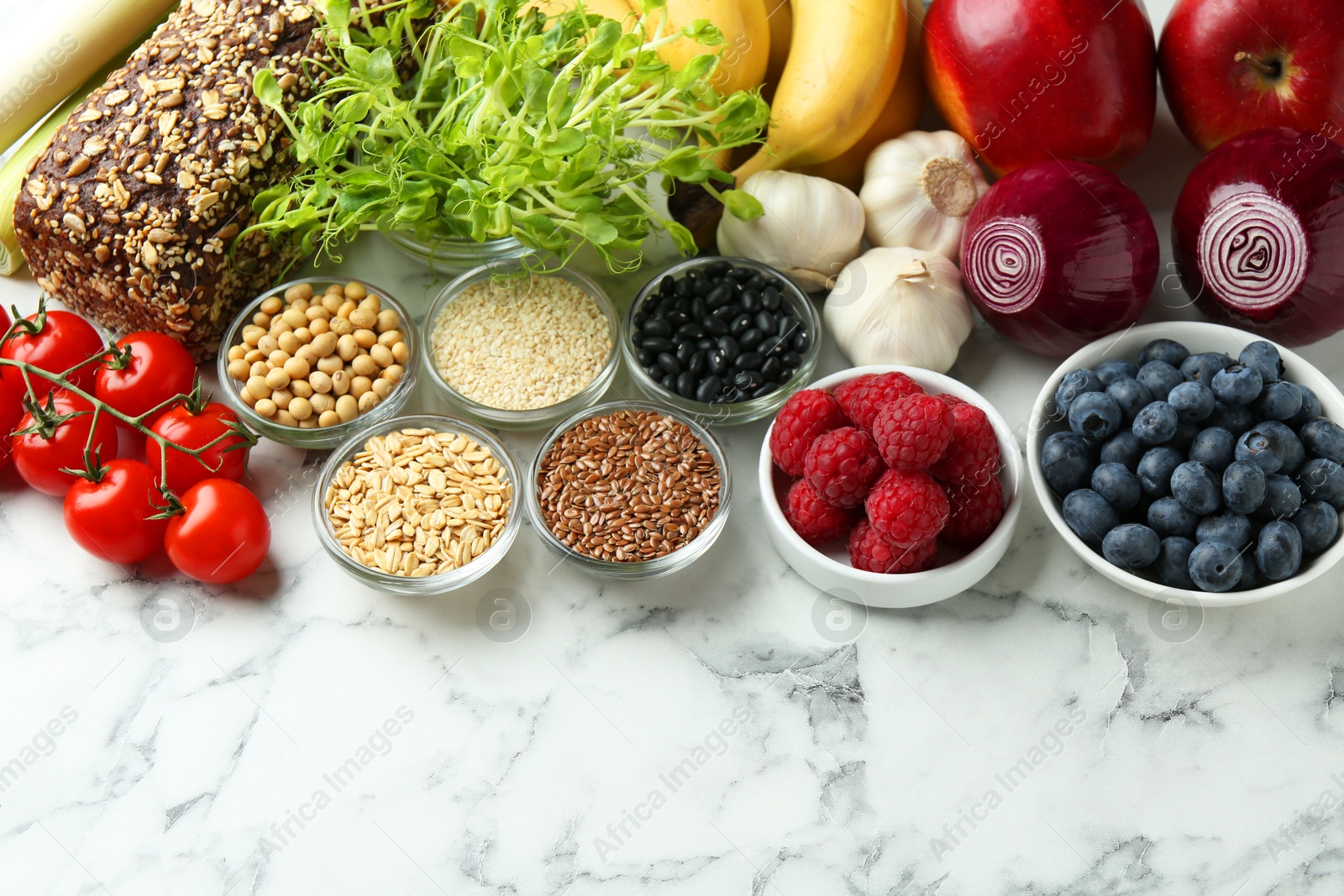 Photo of Different fresh products on white table, space for text. Source of prebiotics