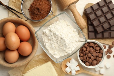 Photo of Flat lay composition with flour, eggs and other ingredients for making dough on light table