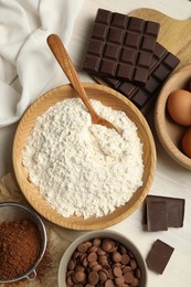 Photo of Flat lay composition with flour and chocolate for making dough on light table