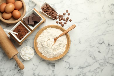 Photo of Flat lay composition with flour, chocolate and other ingredients for making dough on white marble table. Space for text