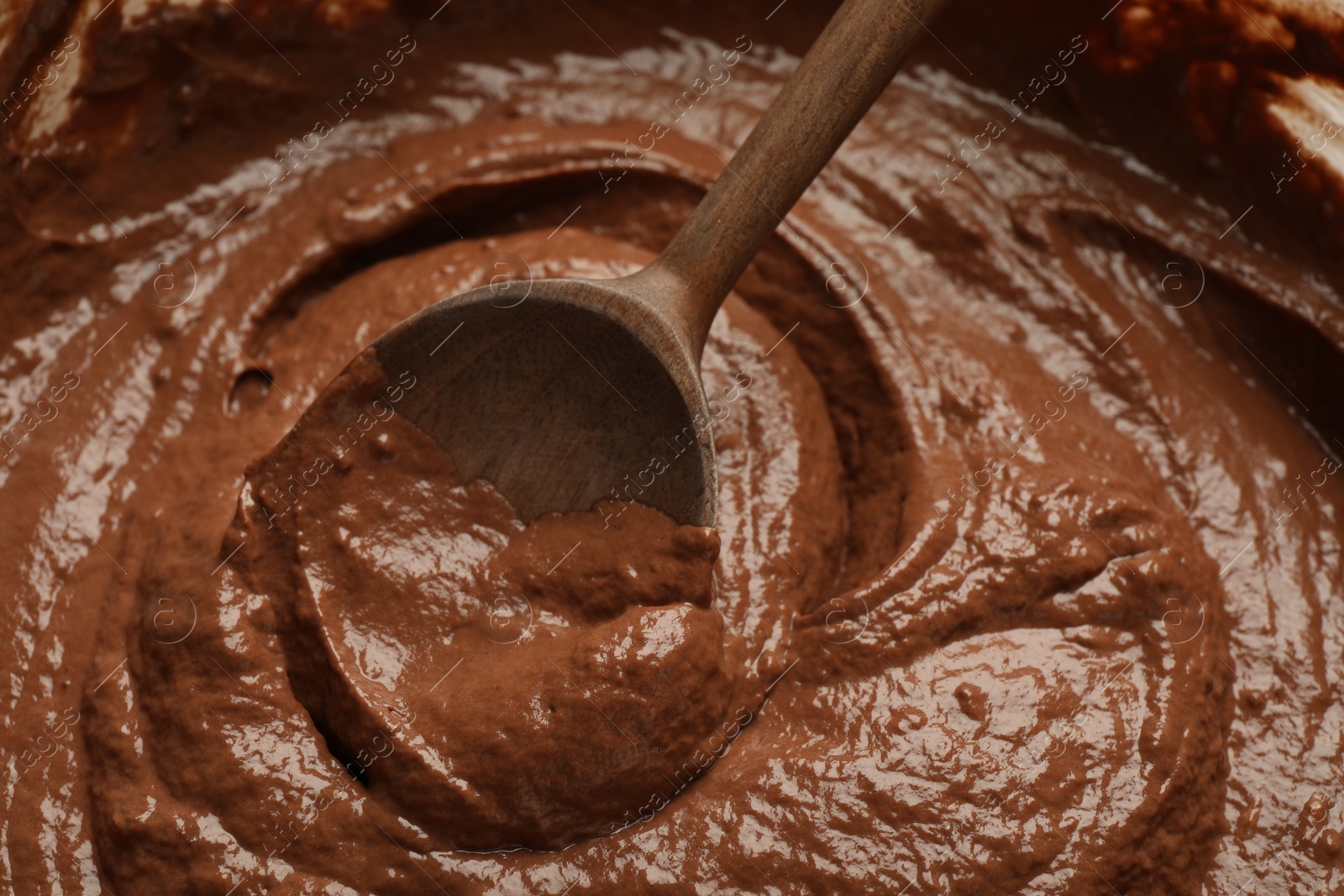 Photo of Chocolate dough and spoon as background, closeup