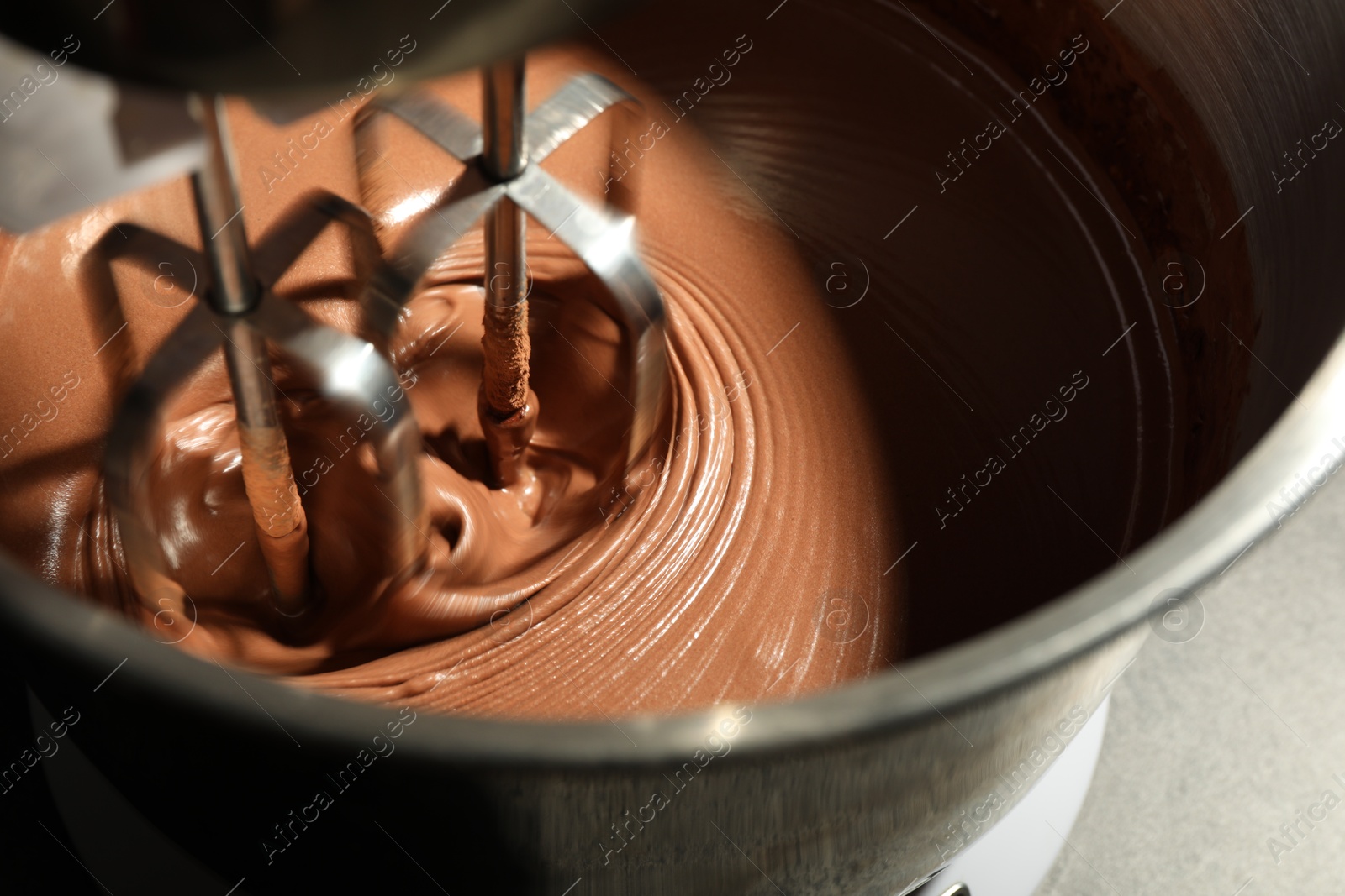 Photo of Mixing chocolate dough in bowl, closeup view