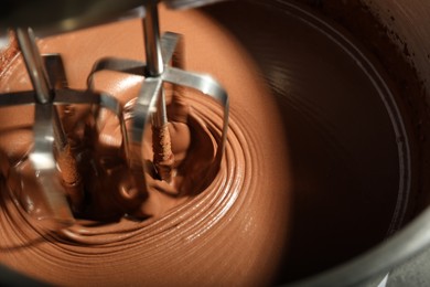 Photo of Mixing chocolate dough in bowl, closeup view