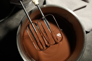 Photo of Chocolate dough in bowl and mixer on grey table, top view