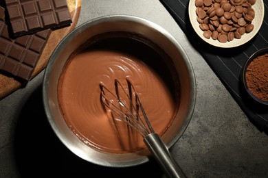 Chocolate dough in bowl and ingredients on grey table, flat lay