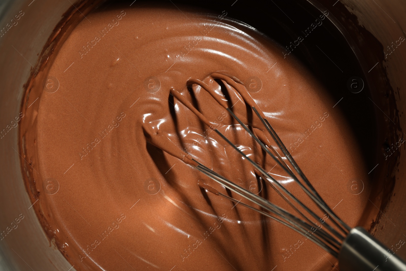 Photo of Mixing chocolate dough with whisk, top view