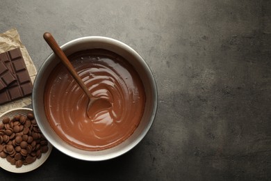 Photo of Chocolate dough in bowl and ingredients on grey table, flat lay. Space for text