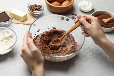 Photo of Woman making chocolate dough at light table, closeup