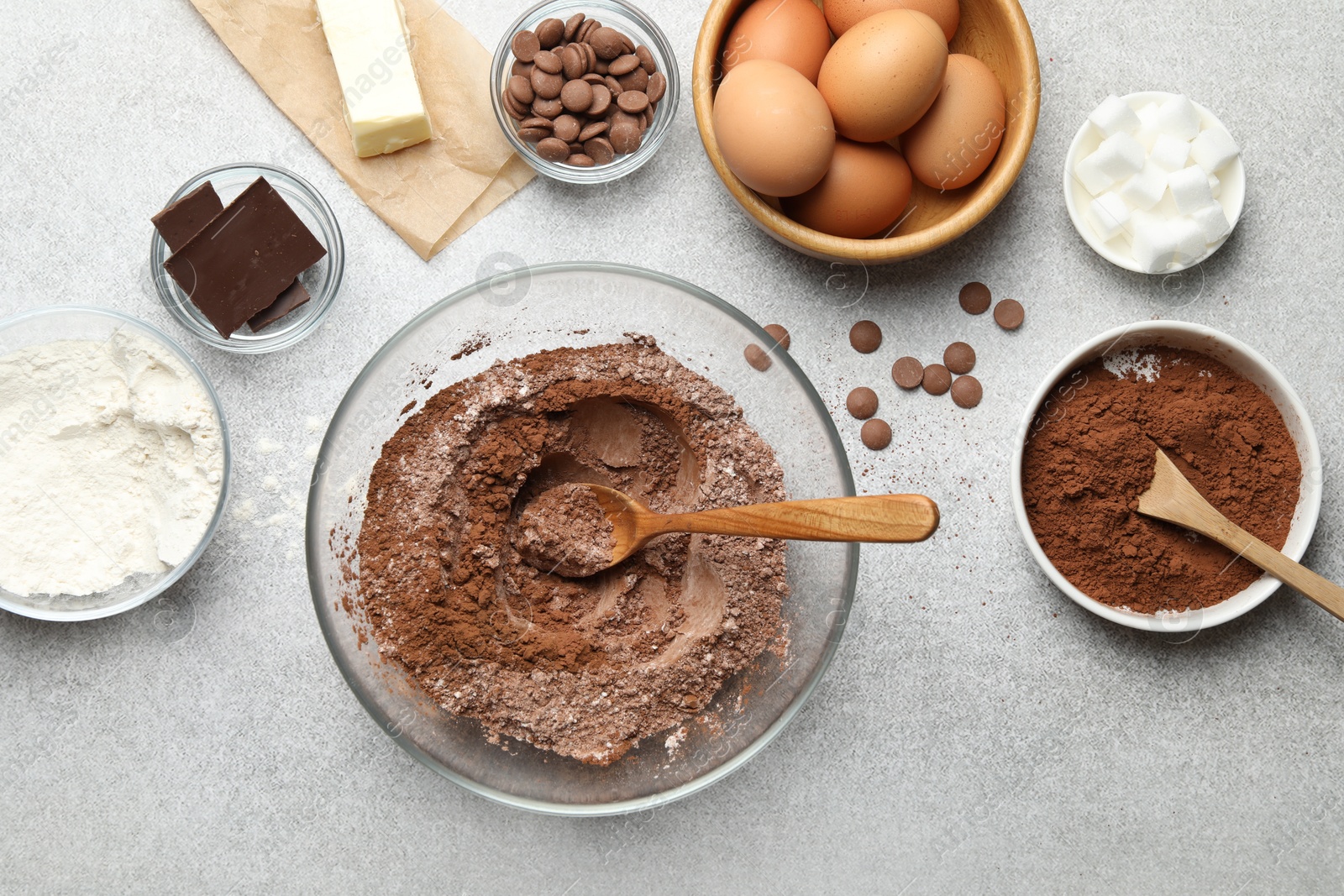 Photo of Ingredients for chocolate dough on light table, flat lay