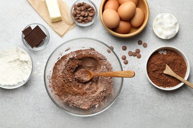 Photo of Ingredients for chocolate dough on light table, flat lay