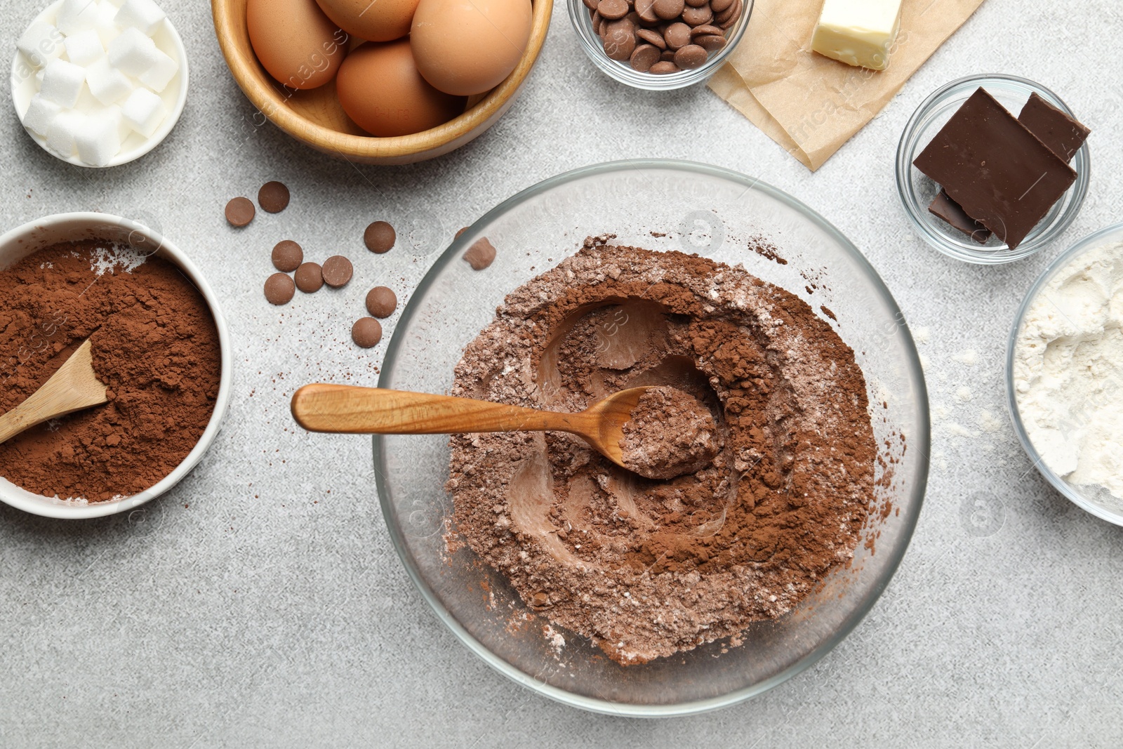 Photo of Ingredients for chocolate dough on light table, flat lay