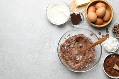 Photo of Ingredients for chocolate dough on light table, flat lay. Space for text