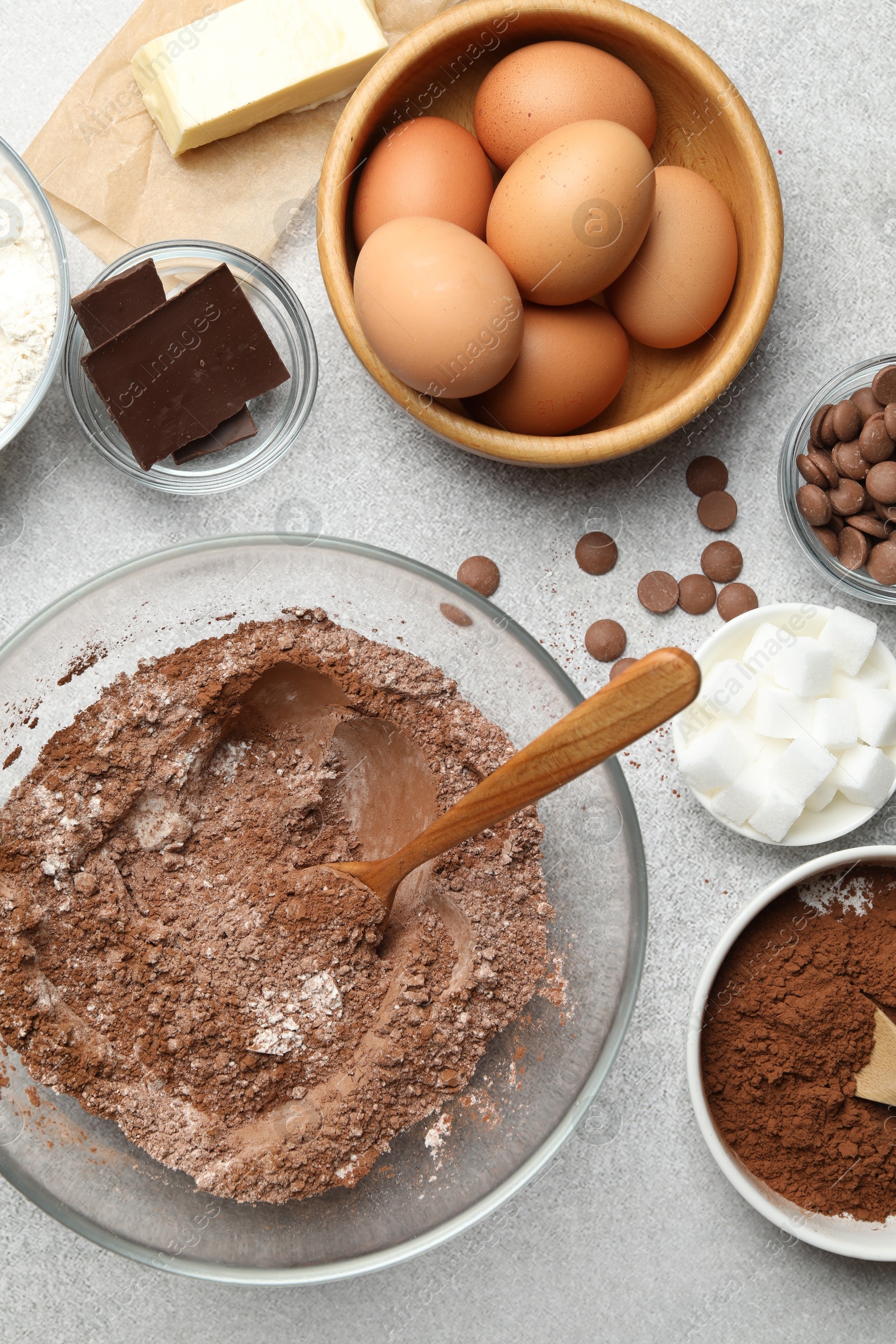 Photo of Ingredients for chocolate dough on light table, flat lay