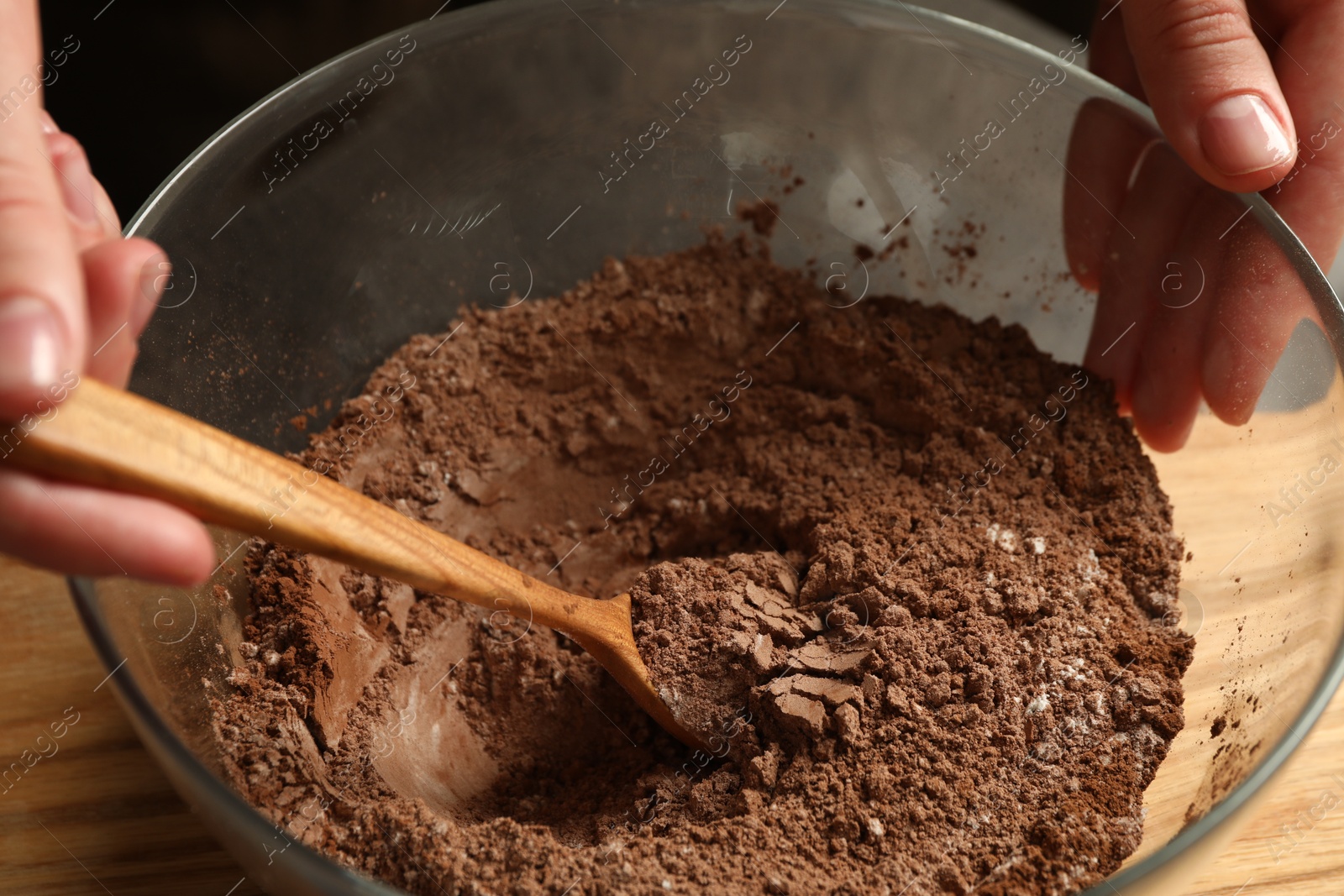 Photo of Woman making chocolate dough at table, closeup