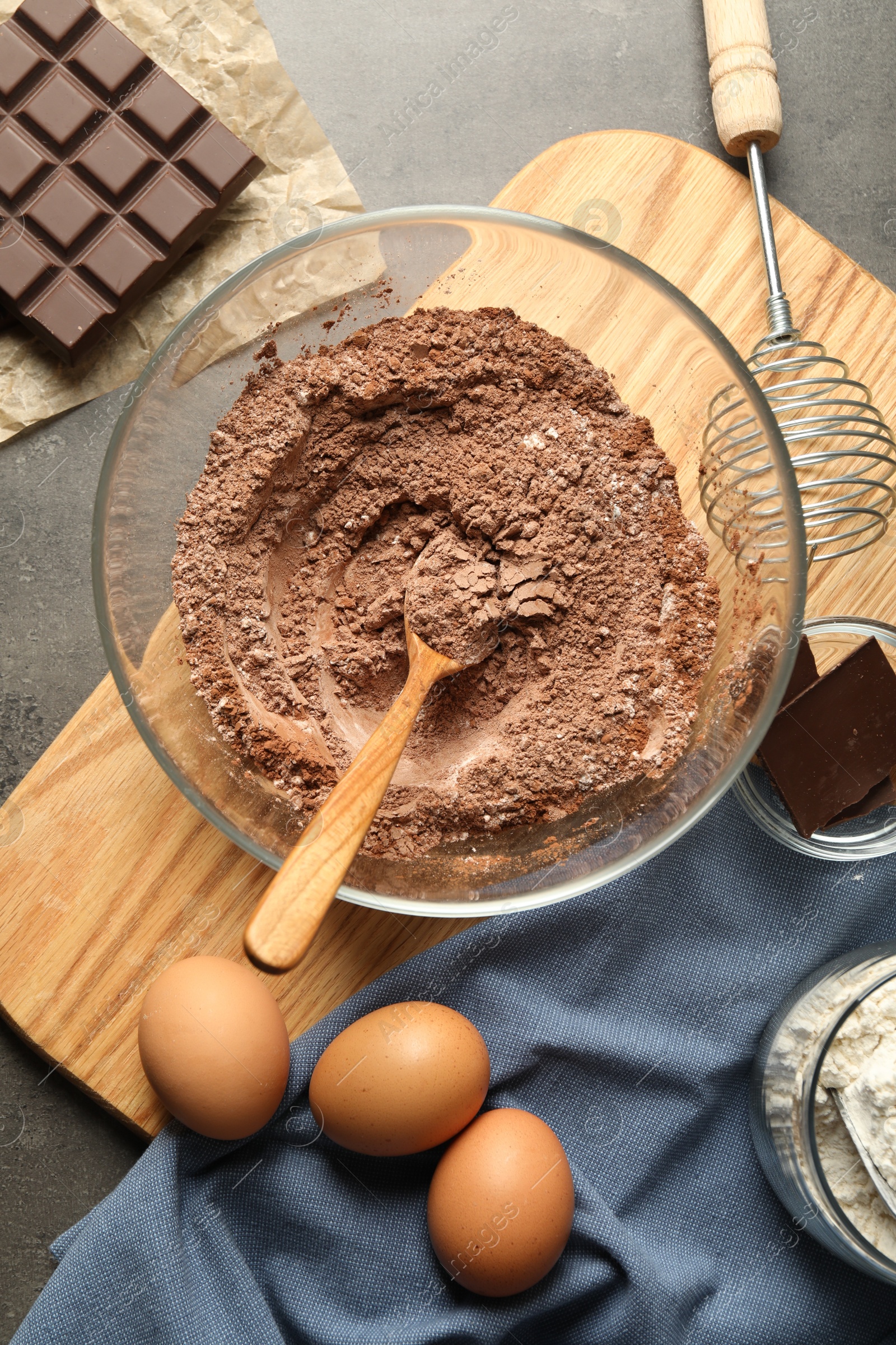 Photo of Ingredients for chocolate dough on grey table, flat lay