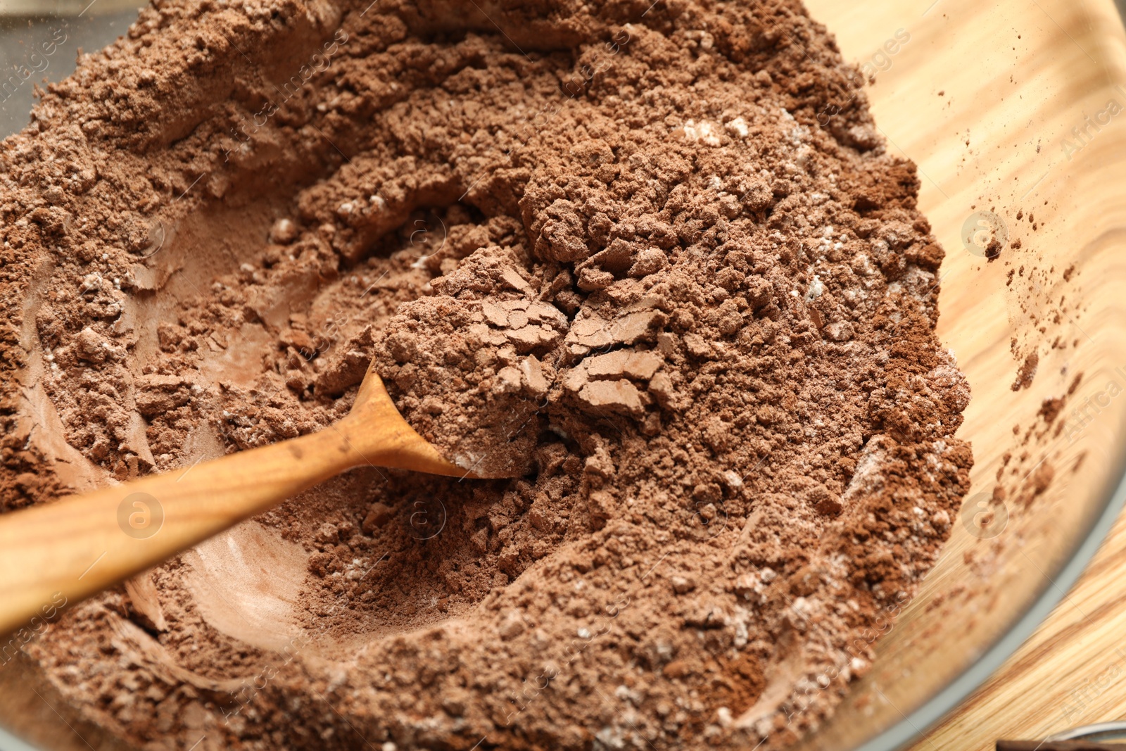 Photo of Making chocolate dough. Mix of cocoa powder with flour and spoon in bowl on table, top view