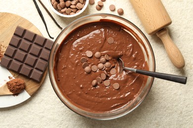 Photo of Melting chocolate chips for dough in bowl on light table, top view