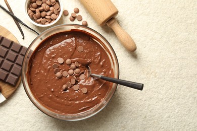 Photo of Melting chocolate chips for dough in bowl on light table, top view