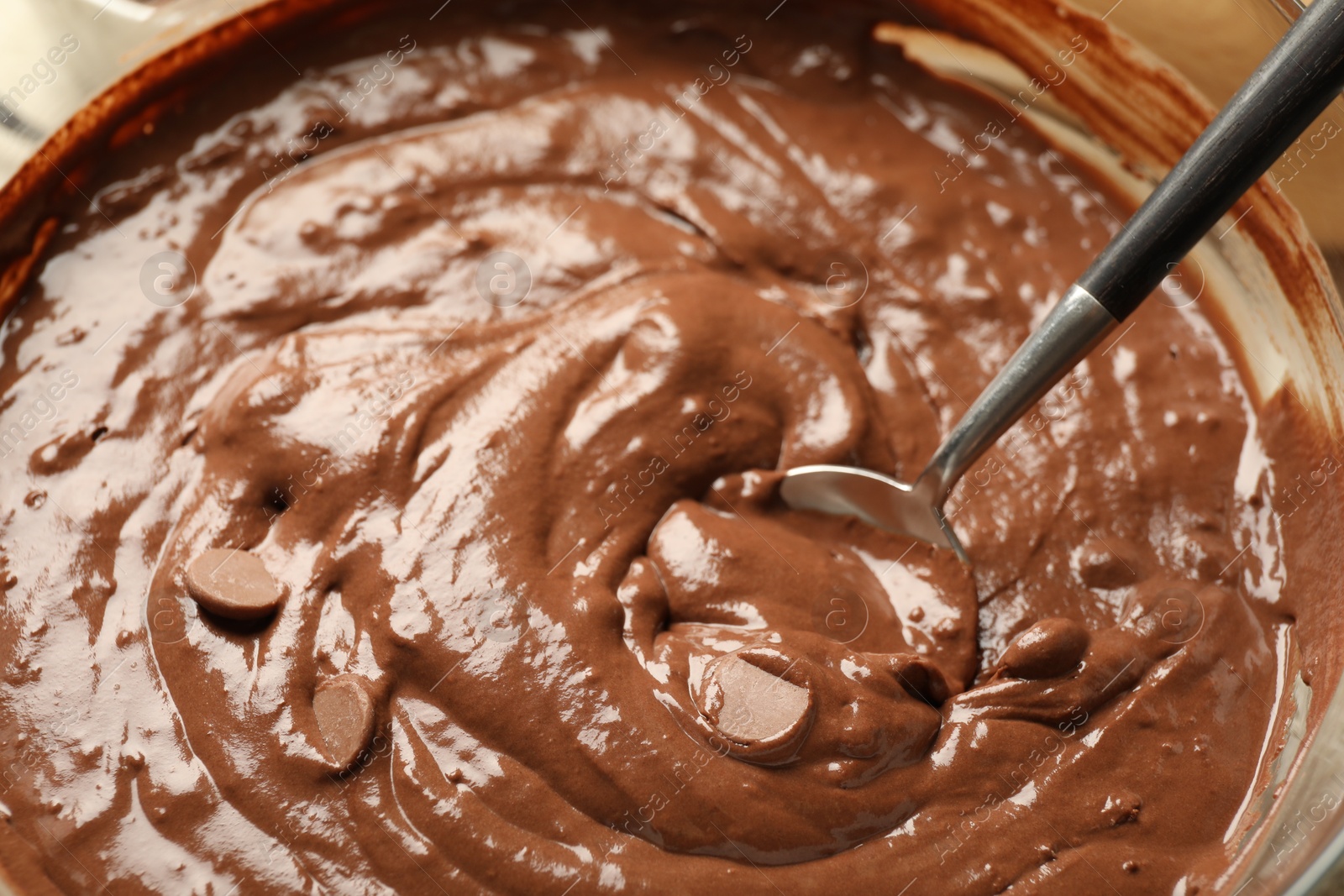 Photo of Melting chocolate chips for dough in bowl, closeup