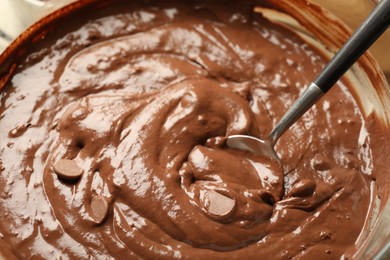 Photo of Melting chocolate chips for dough in bowl, closeup