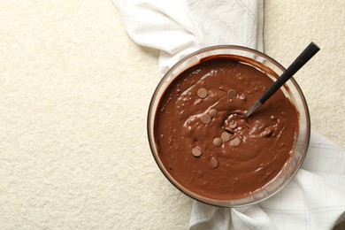 Photo of Melting chocolate chips for dough in bowl on light table, top view. Space for text