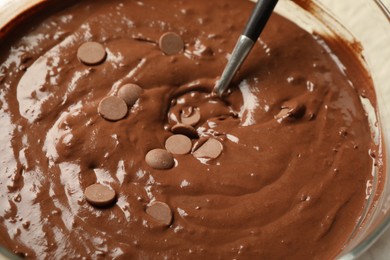 Photo of Melting chocolate chips for dough in bowl, closeup