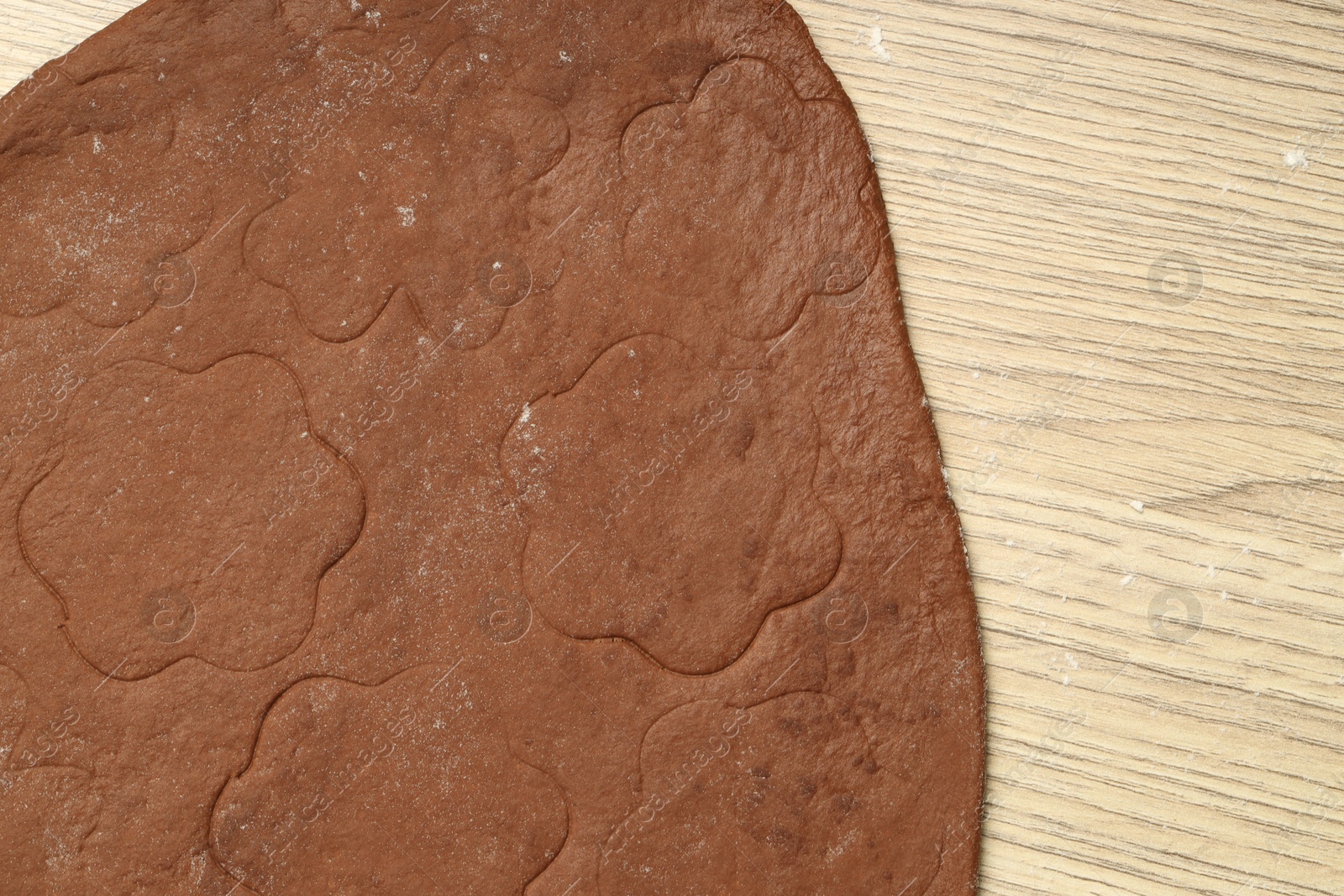 Photo of Chocolate dough on wooden table, top view