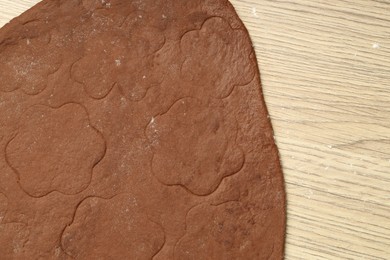 Photo of Chocolate dough on wooden table, top view