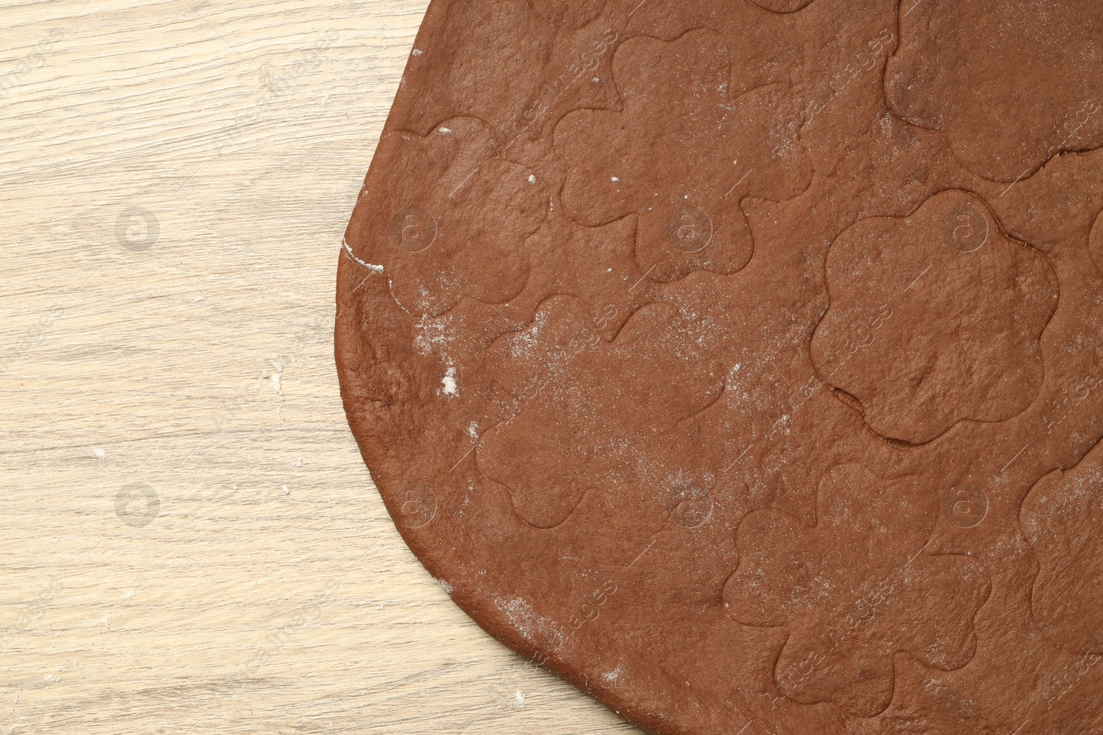 Photo of Chocolate dough on wooden table, top view. Space for text