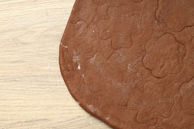 Photo of Chocolate dough on wooden table, top view. Space for text