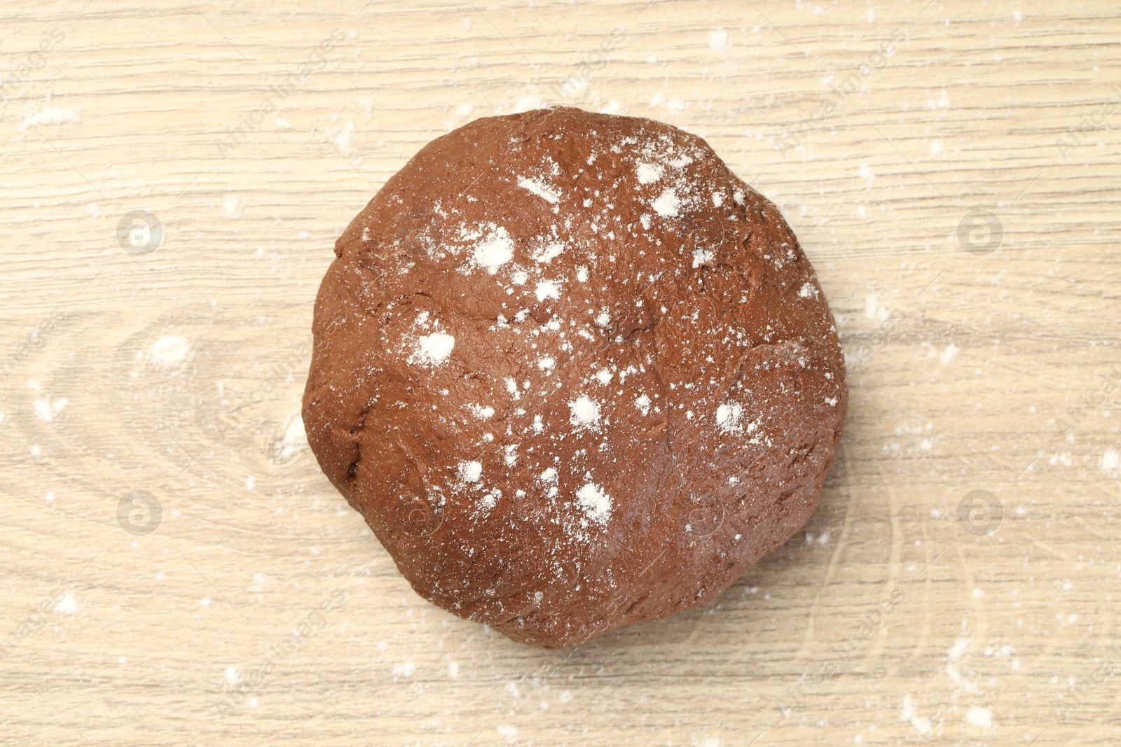 Photo of Chocolate dough on wooden table, top view