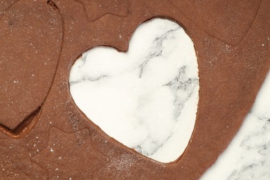 Photo of Chocolate dough on white marble table, top view