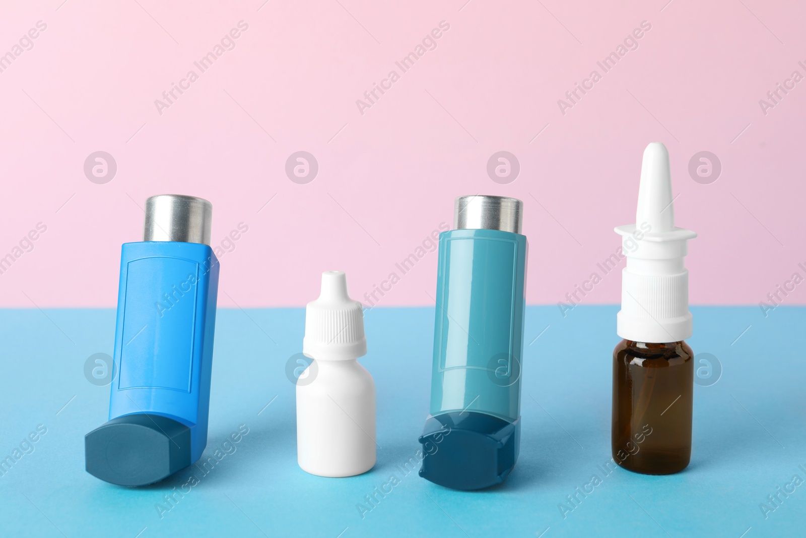 Photo of Different asthma medications on color background, closeup